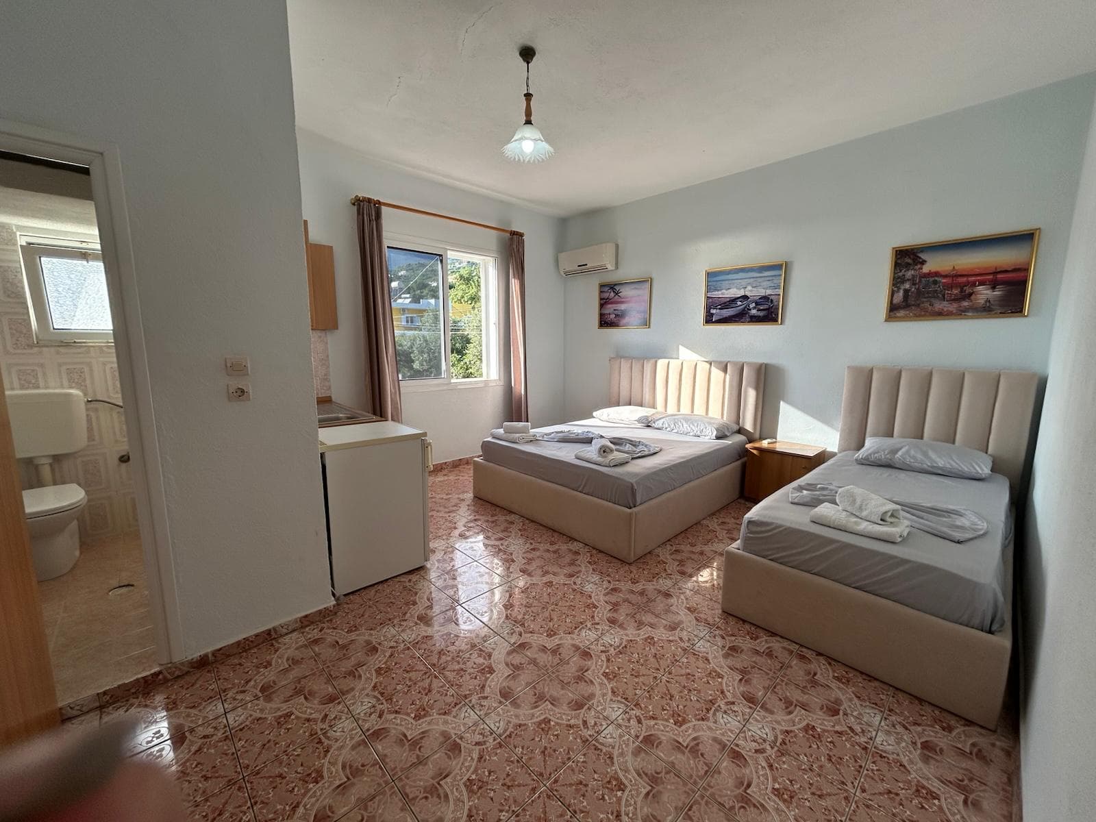 Triple room with double and single beds at Kristaqi Rooms
